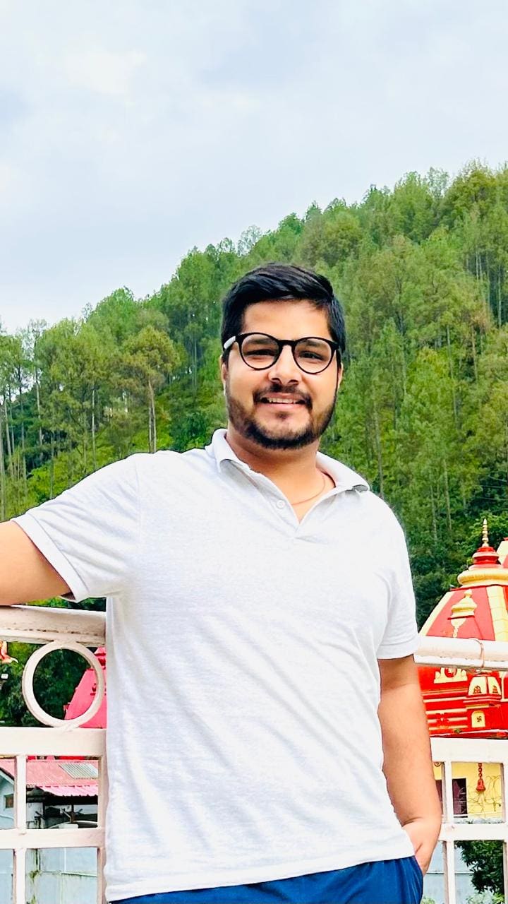 Company chartered accountant with glasses and a contented smile enjoying a break at a scenic mountain retreat, embodying our corporate values of work-life balance.